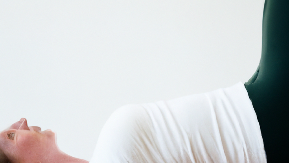 alt_text: Woman doing Pilates in a bright, modern studio with natural light and greenery.